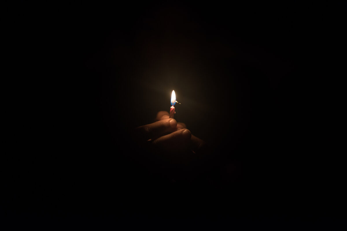 Image of hand holding a burning flame