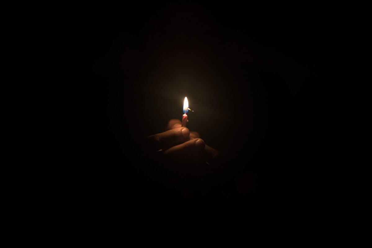 Image of hand holding a burning flame