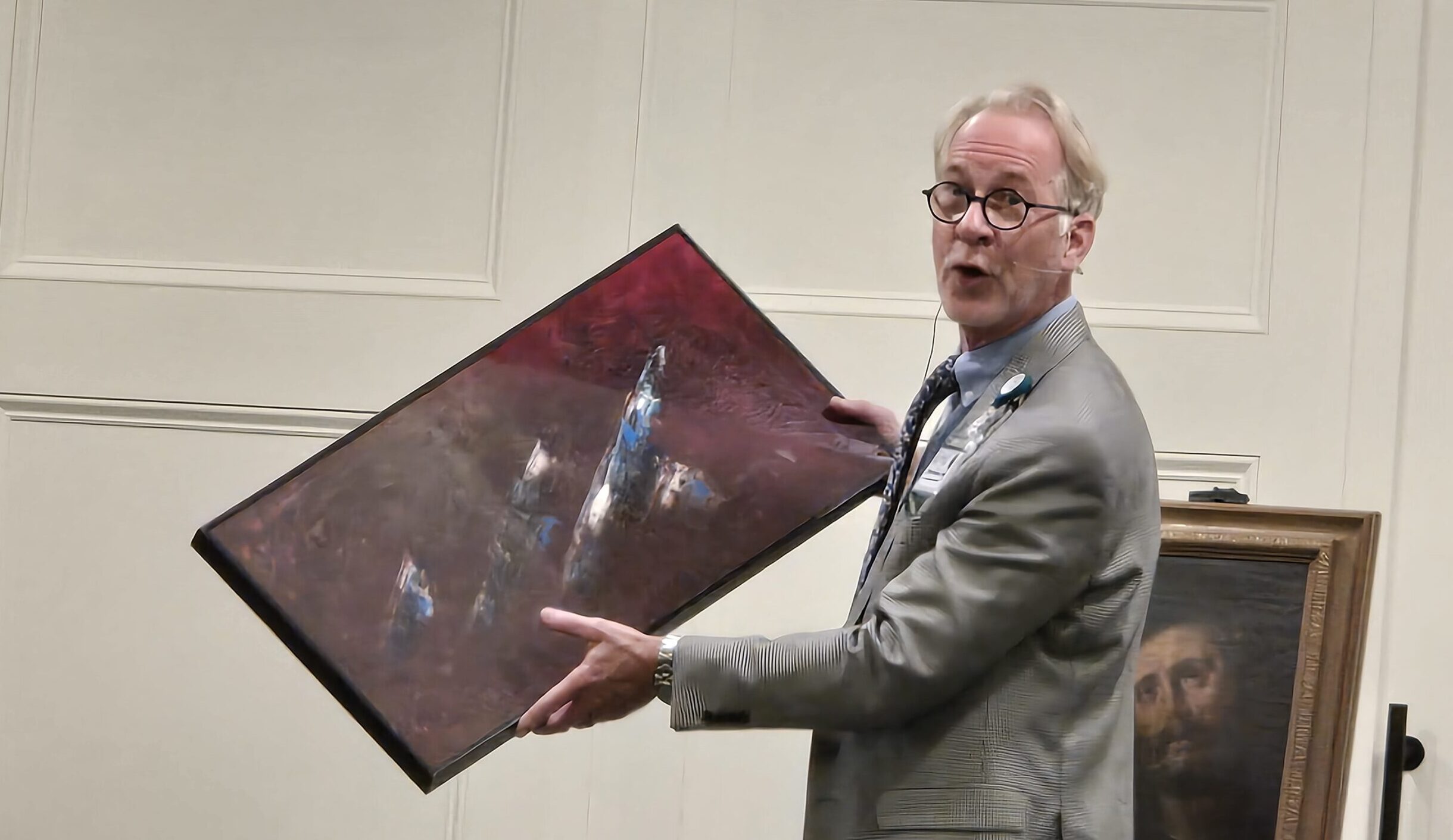 Kevin Stewart demonstrates visual difference in a partially restored painting.