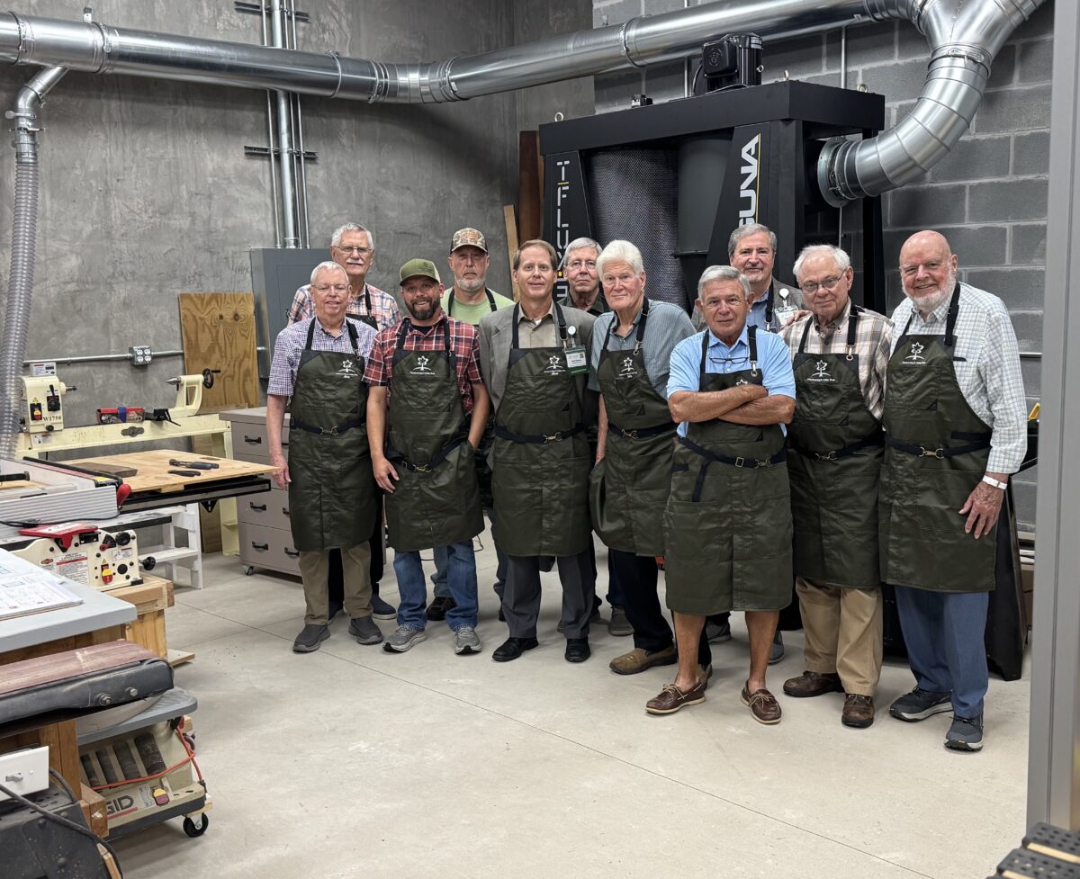 Group of men in Woodworking shop aprons